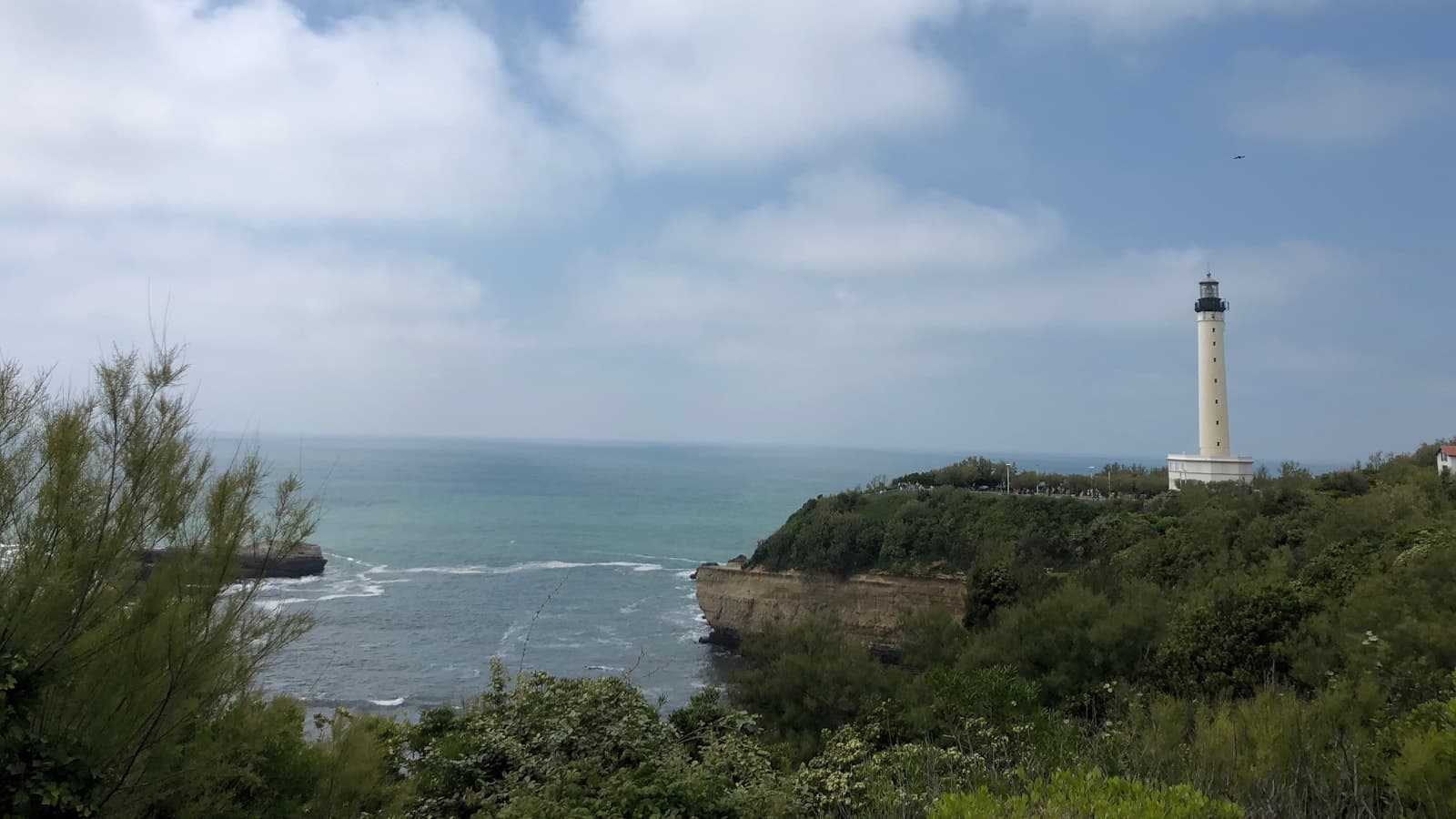 Biarritz lighthouse above the Atlantic surf at late afternoon.