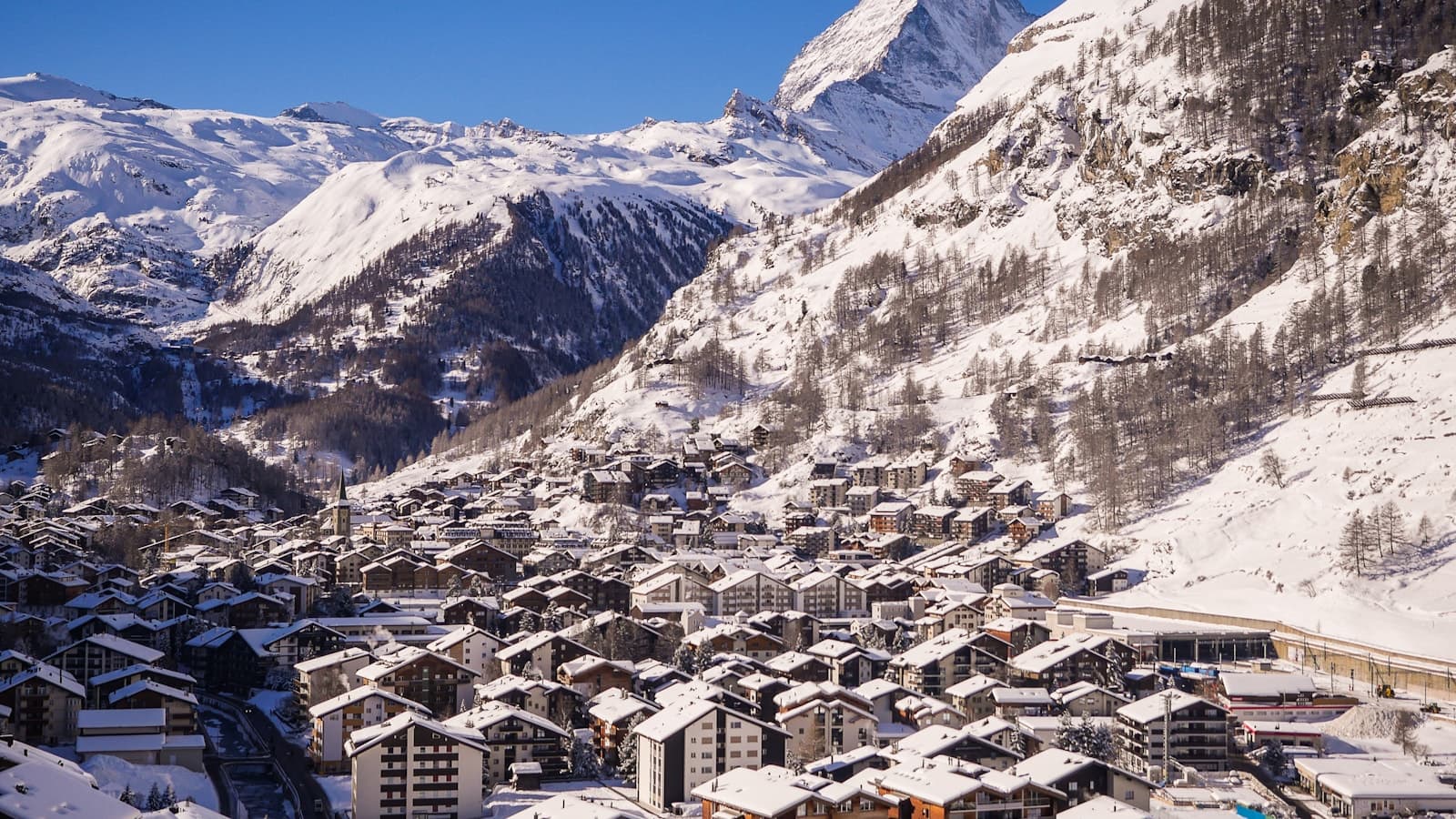 The Matterhorn at dawn above the rooftops of Zermatt.